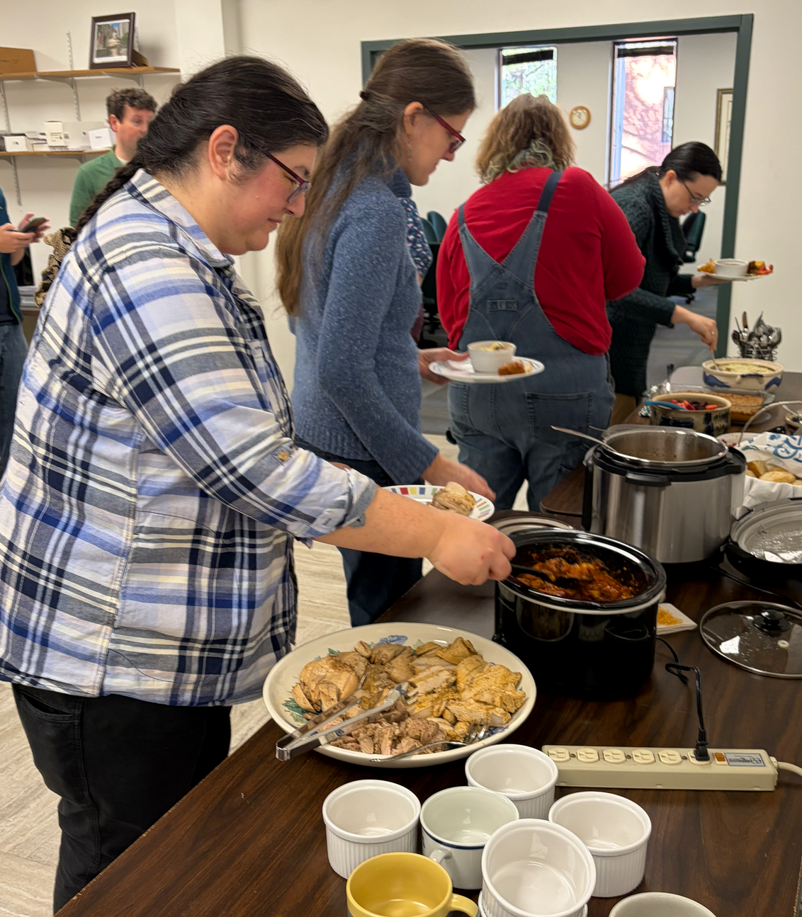 The buffet line as Mitake, Katharina, Marion, and Katy load up their plates.