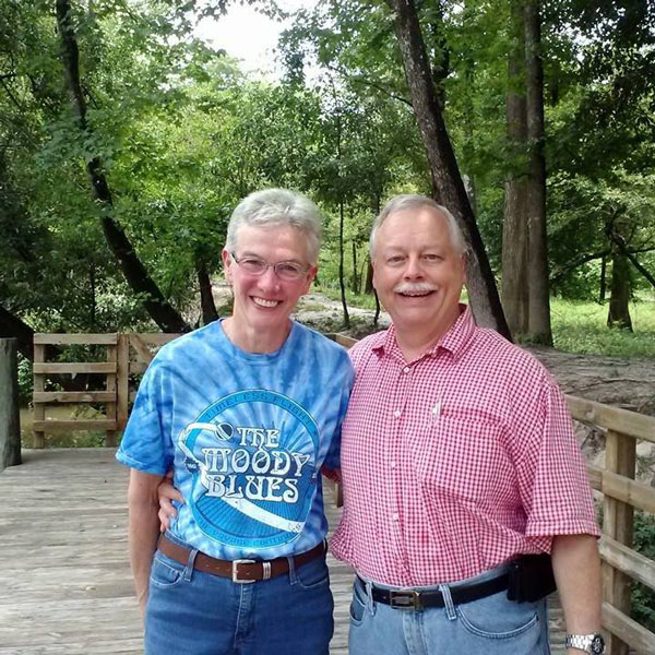 A photo of Brian and Aimée smiling together.