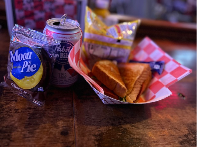 A fried bologna sandwich with a bag of Lay’s potato chips, a PBR, & a Moon Pie strongly recommended by Michael Lang. Available at Robert’s Western World for the low price of six bucks.